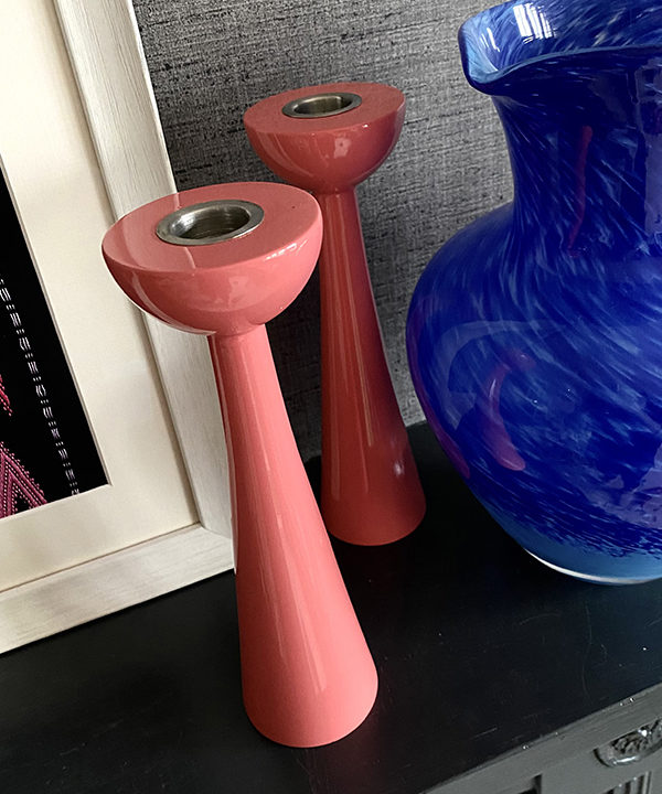 Pink candlesticks in gloss Coral with a retro, Scandinavian-style silhouette.