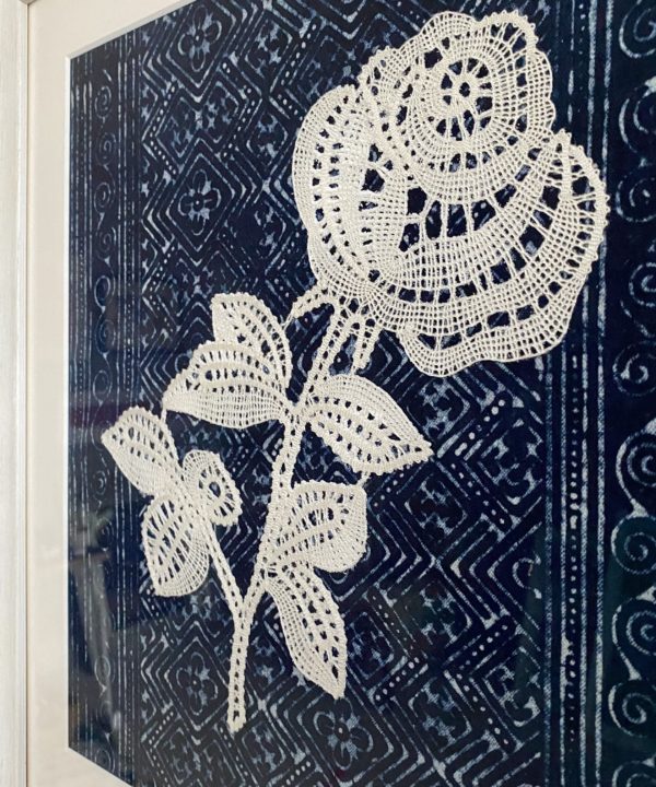 Detail of a Slovenian bobbin lace rose textile art.