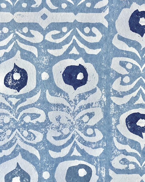 Detail of a hand-printed, pale blue wallpaper with a Middle Eastern-inspired design.