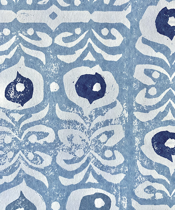 Detail of a hand-printed, pale blue wallpaper with a Middle Eastern-inspired design.