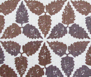 A brown patterned cushion fabric, hand-printed on linen and available as handmade cushions in two sizes.