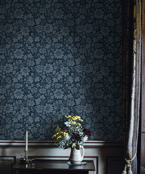 Folk art wallpaper with a modern twist in a deep grey/blue hue.