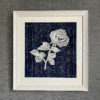 Textile art lace rose displayed against hand-dyed Thai indigo cloth.