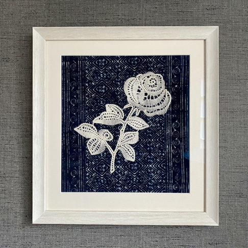 Textile art lace rose displayed against hand-dyed Thai indigo cloth.