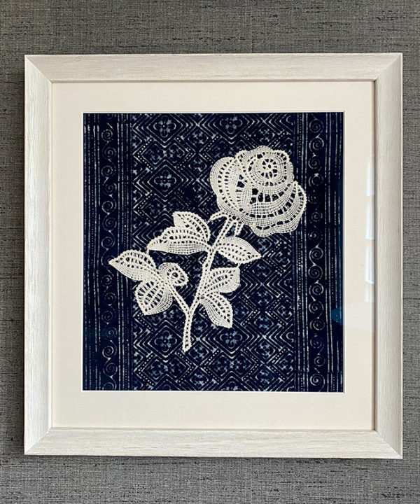 Textile art lace rose displayed against hand-dyed Thai indigo cloth.