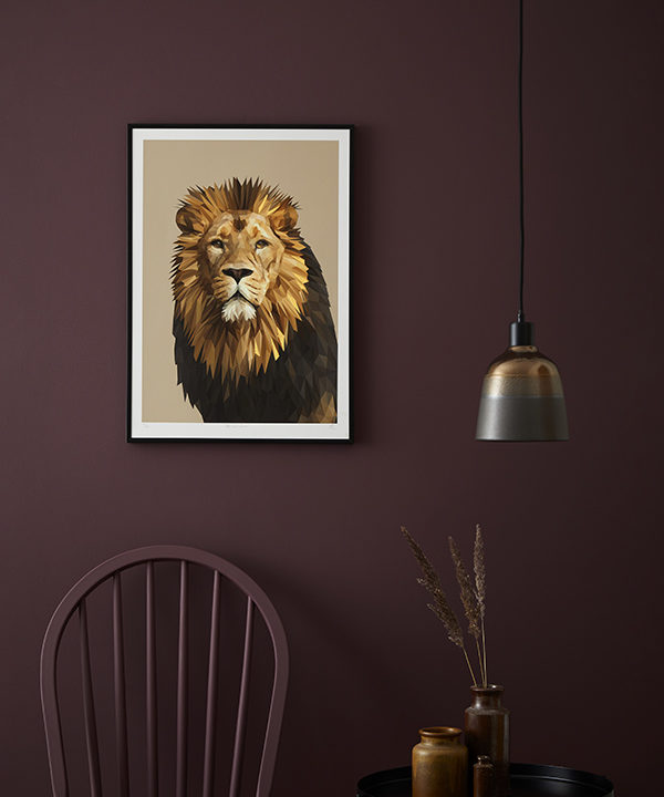 A majestic lion portrait is displayed against a deep aubergine painted wall.