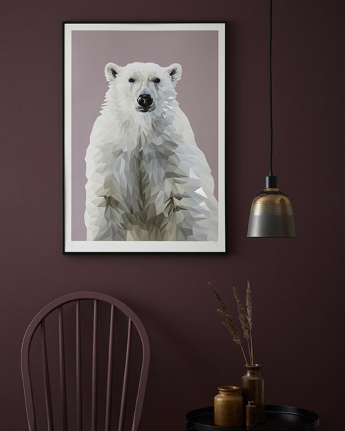 A polar bear print against a painted plum-coloured wall.