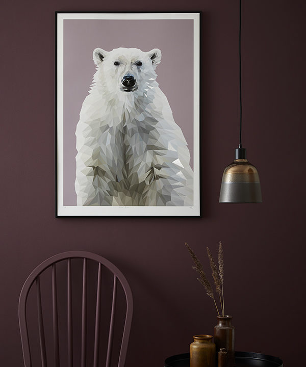 A polar bear print against a painted plum-coloured wall.