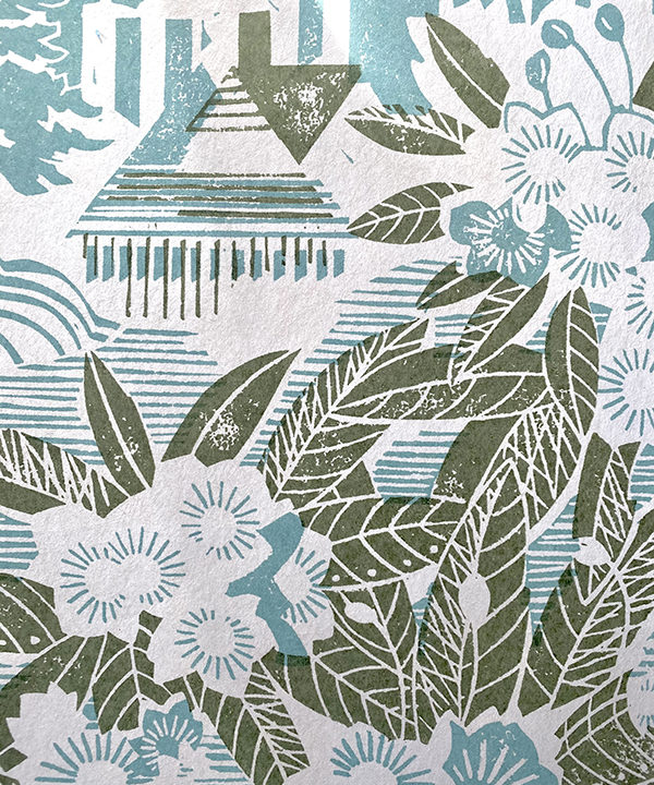 Detail of a country garden wallpaper in a soft peacock blue hue with sage green accents.