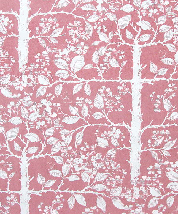 Pink floral wallpaper depicting espaliered fruit trees, hand-printed.