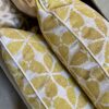 Yellow patterned cushions on hand-printed linen with a chic, Moroccan-style print design.