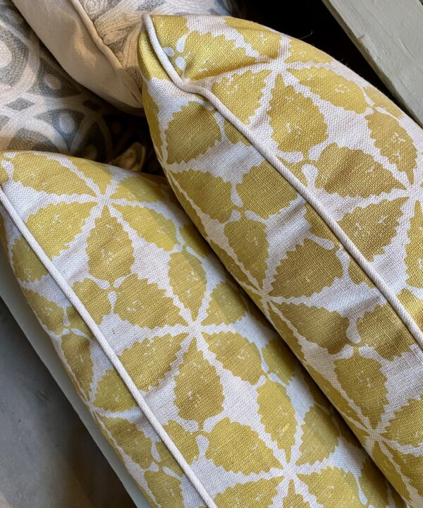 Yellow patterned cushions on hand-printed linen with a chic, Moroccan-style print design.