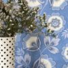 Detail of blue and white folk-inspired floral wallpaper by Olenka Design.