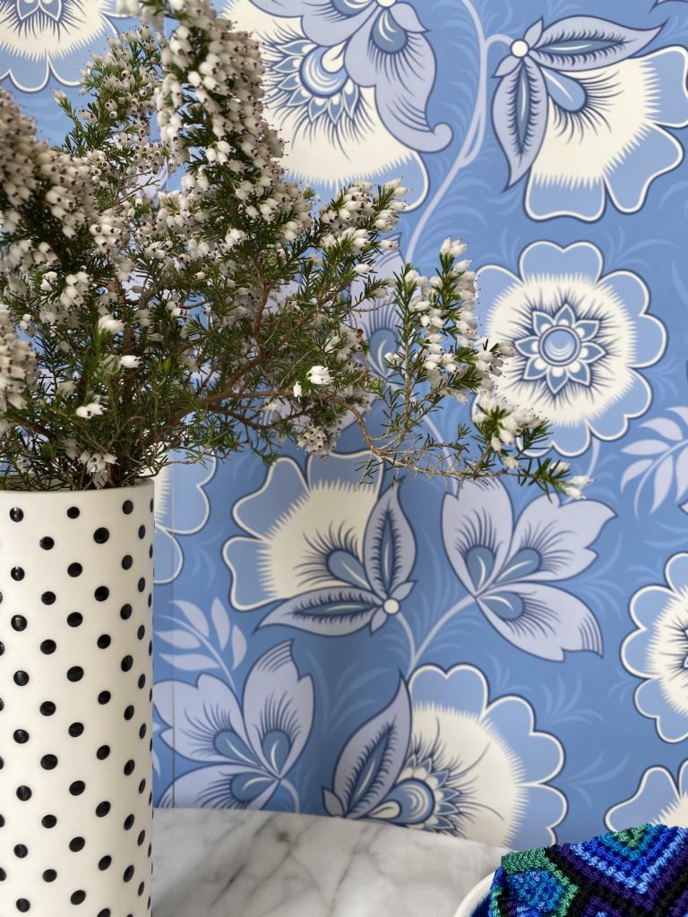 Detail of blue and white folk-inspired floral wallpaper by Olenka Design.