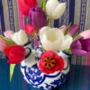 A Dutch Delft-style tulip vase displaying a cheerful array of tulips!