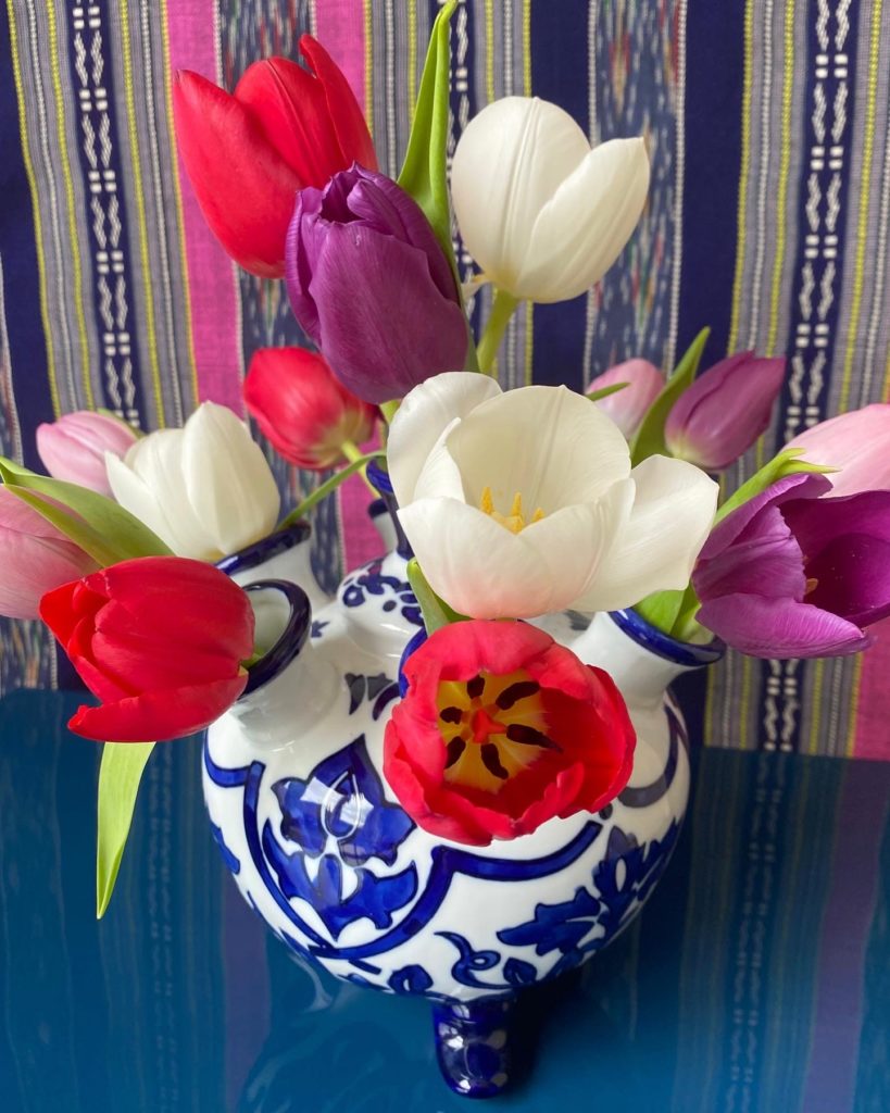 A Dutch Delft-style tulip vase displaying a cheerful array of tulips!