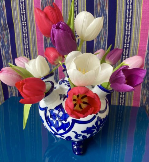 Blue and white Dutch Delft-style vase from Holland with Spring tulip display.