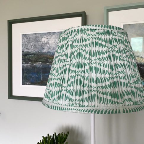 Green lampshades for table lamps are showcased here in a pretty mint colour way. The lampshade is block-printed and handmade in India and is shown here on an elegant sideboard.