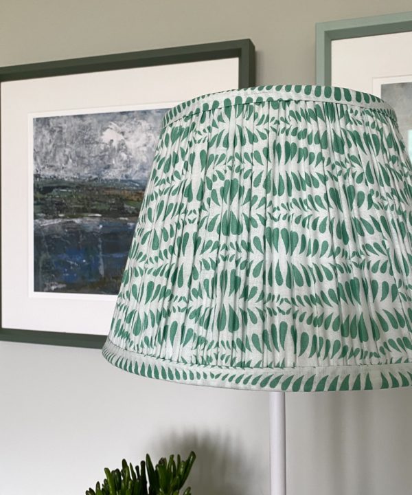 Green lampshades for table lamps are showcased here in a pretty mint colour way. The lampshade is block-printed and handmade in India and is shown here on an elegant sideboard.