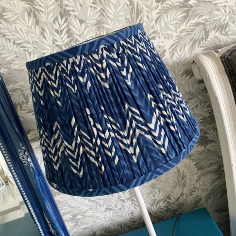 Detail of an indigo blue lampshade in a zig-zag pattern.