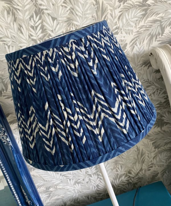 Detail of an indigo blue lampshade in a zig-zag pattern.