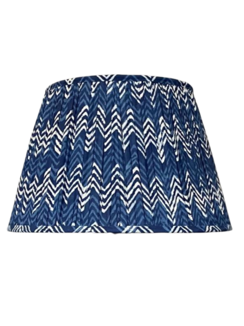 Cut out shot of an indigo blue gathered cotton lampshade with a zig-zag design.