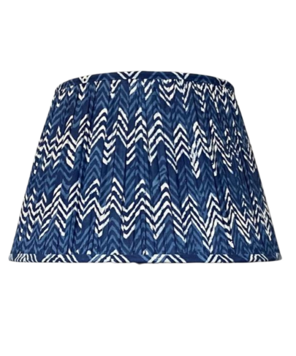 Cut out shot of an indigo blue gathered cotton lampshade with a zig-zag design.