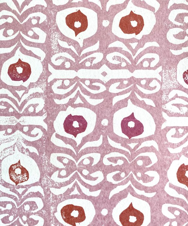 A light pink wallpaper with red and deeper pink accents, inspired by motifs on Middle Eastern ceramics.