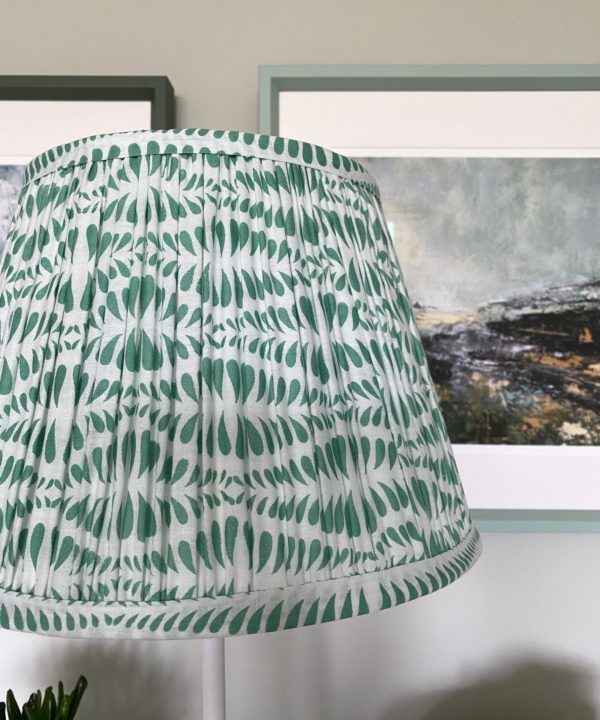 Close-up of a mint-hued small-scale block print on a patterned gathered cotton lampshade.