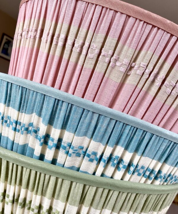 Pretty, pastel lampshades in candy pink, soft blue and soft, sage green.