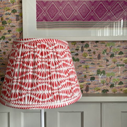 Detail of a cherry red, block-printed, patterned lampshade.