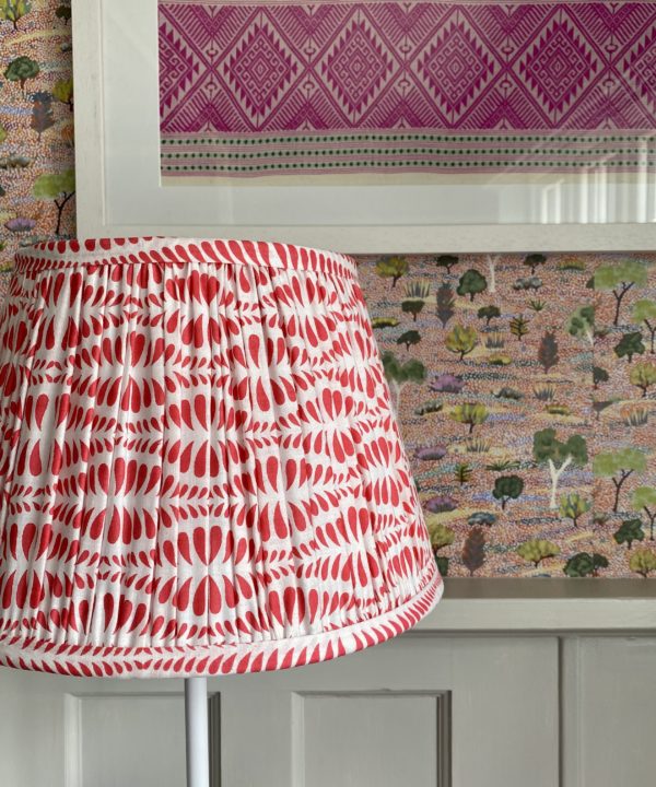 Detail of a cherry red, block-printed, patterned lampshade.