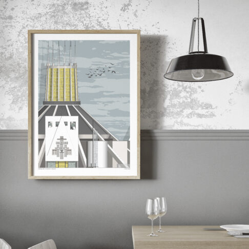 An art print of Liverpool Metropolitan Cathedral in a modern, grey dining space with an industrial pendant lamp.