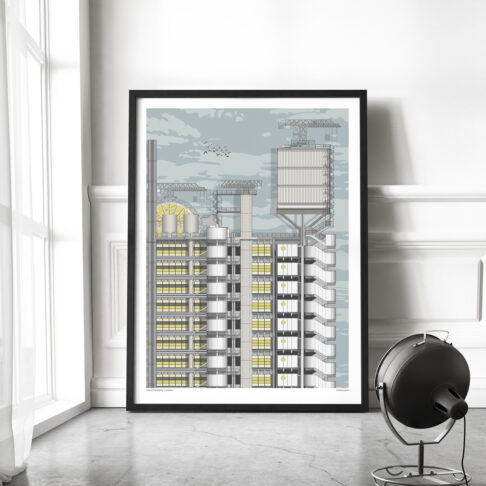 A large format print of the Lloyds building London with a slim black frame, leaned against the wall in a contemporary living space.