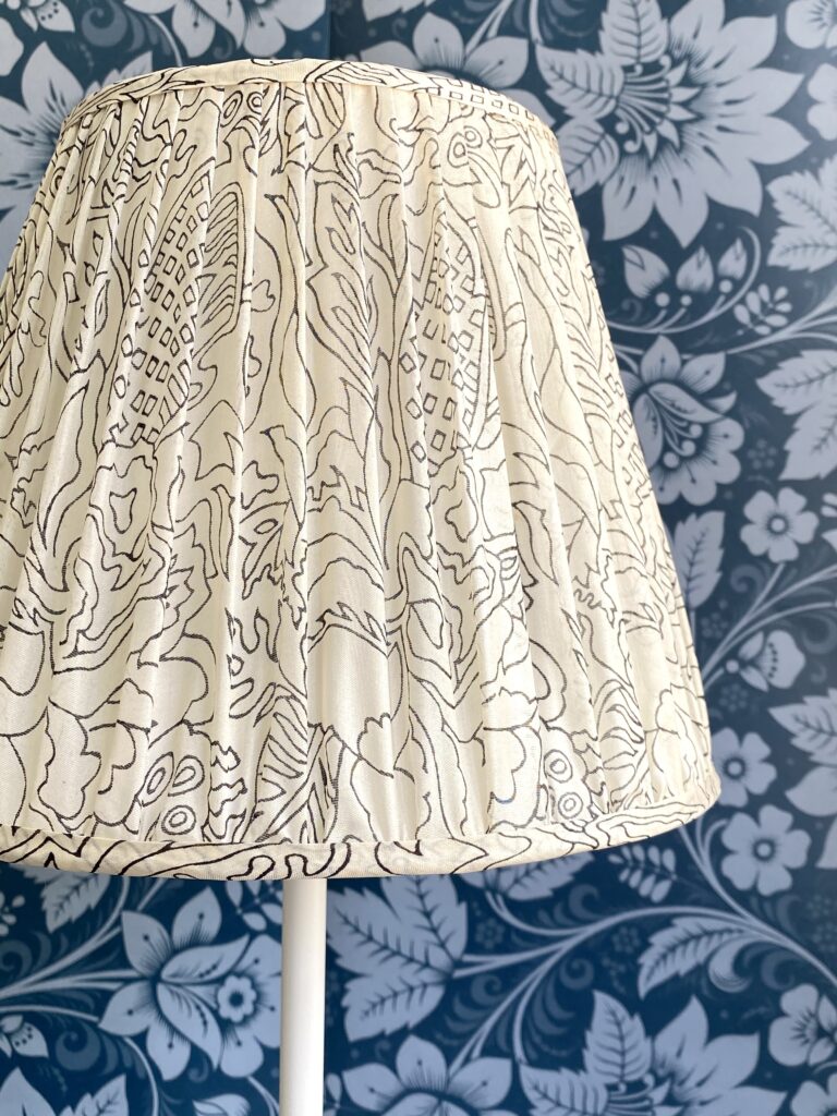 Close-up shot of a patterned, black and white, gathered silk lampshade.