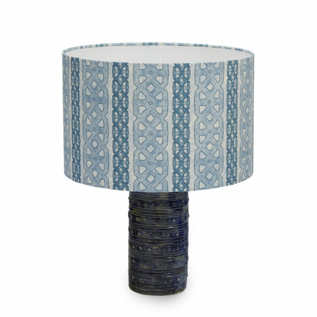 A ceramic pottery lamp base and shade with a blue, west African-inspired print from Eva Sonaike.