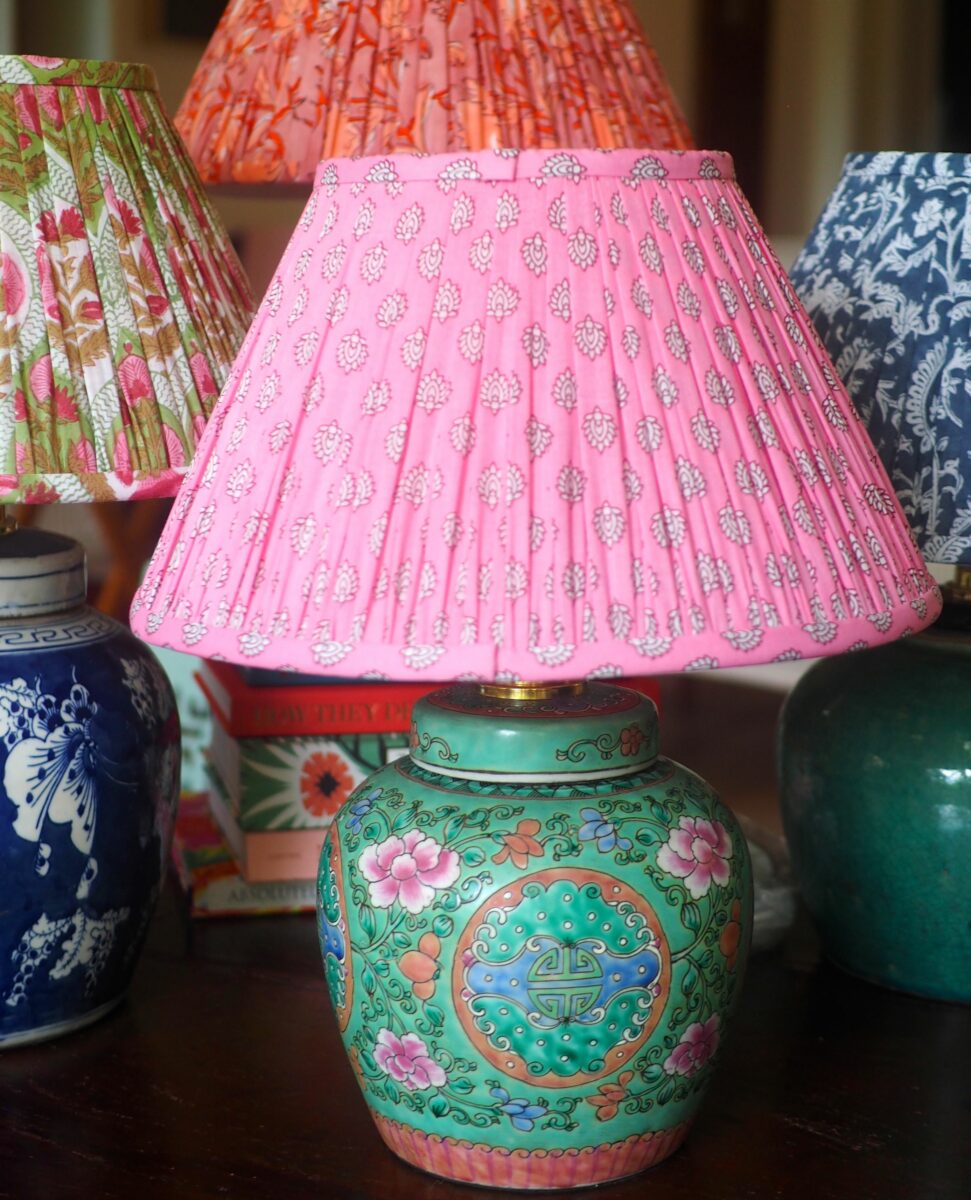 A jade Chinese Ginger jar lamp base with pink, block-print shade.