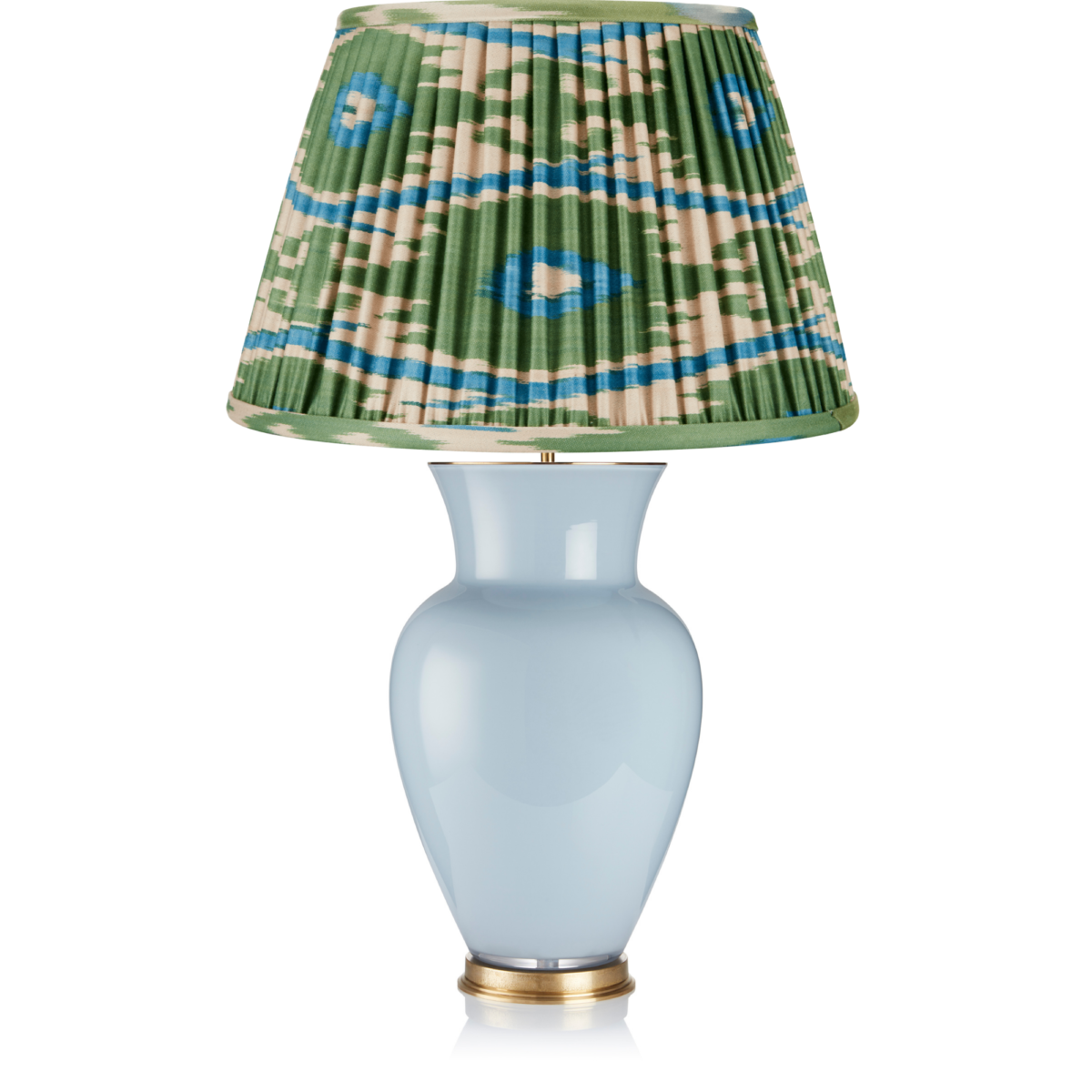 An elegant, silk Ikat gathered lampshade on a simple, sky blue, urn-shaped lamp base.