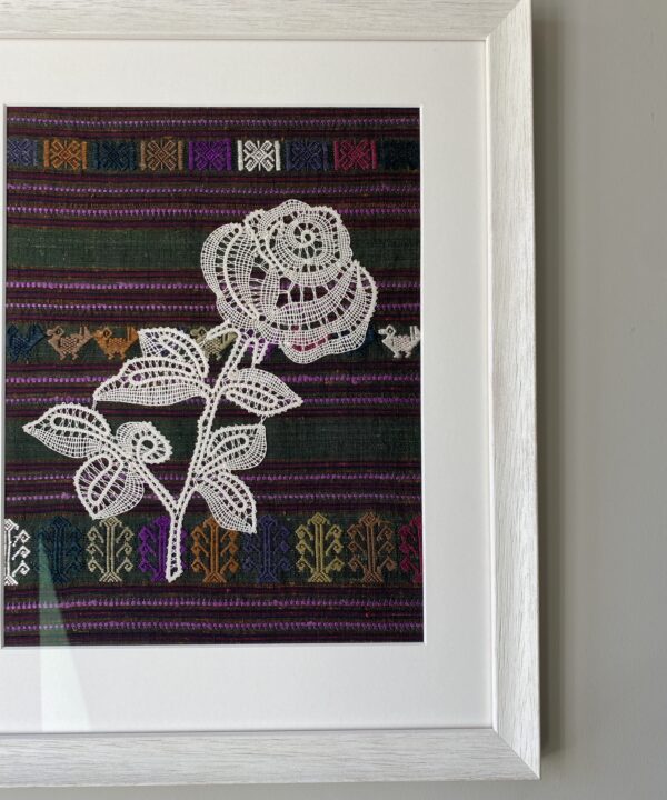 A Croatian lace rose handmade and framed in white against hand-woven Thai silk.