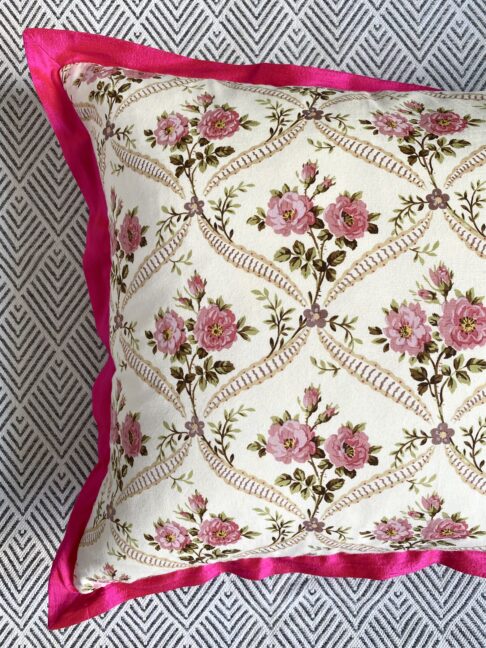 Vintage floral cushions with French-feel rosebud trellis design and hot pink, silk trim.