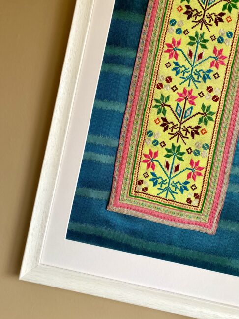 A vintage Thai textile framed against silk.