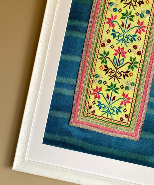 A vintage Thai textile framed against silk.