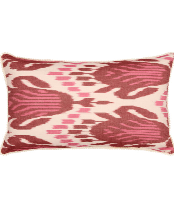 A burgundy and magenta rectangular cushion in silk Ikat with bobble trim.