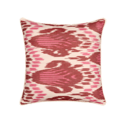 Red Ikat cushions in deep magenta pink and burgundy silk in a square shape with bobble trim.