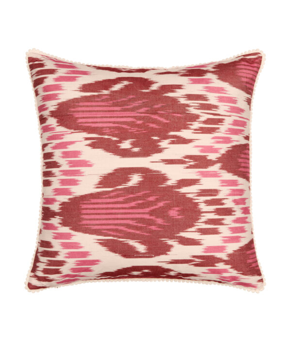 Red Ikat cushions in deep magenta pink and burgundy silk in a square shape with bobble trim.