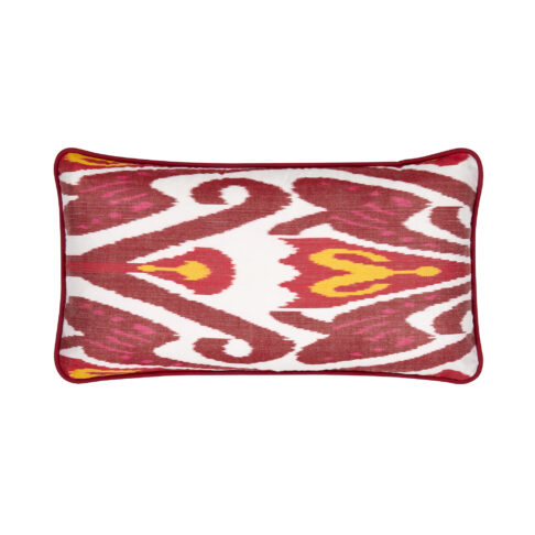 A rectangular silk Ikat cushion in deep reds, white and yellow with a co-ordinating satin trim.