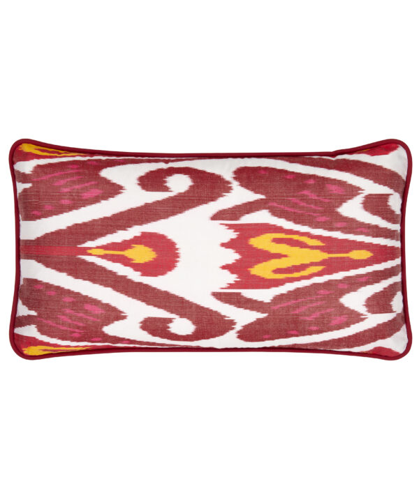 A rectangular silk Ikat cushion in deep reds, white and yellow with a co-ordinating satin trim.