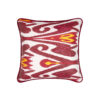 Red and white cushions with a yellow accent in a striking, luxury, silk Ikat.