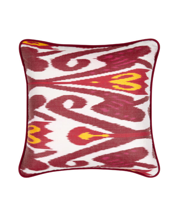 Red and white cushions with a yellow accent in a striking, luxury, silk Ikat.