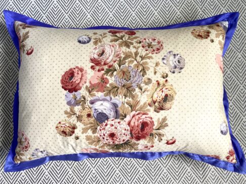 A vintage floral chintz cushion with a royal blue silk trim and tartan reverse (not shown).